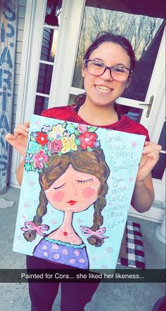 a woman holding up a painting that says painted for corashe liked her likeness