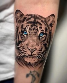 a tiger with blue eyes on the arm