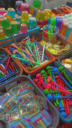 there are many plastic objects on display at the market table, including toothbrushes and other items