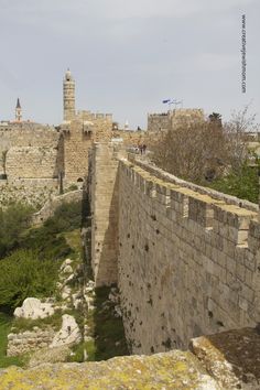 an old stone wall and tower in the background