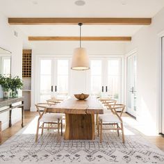 a dining room table with chairs and a bowl on it