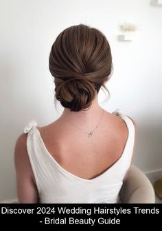 the back of a woman's head wearing a wedding hairstyles and bridal beauty guide