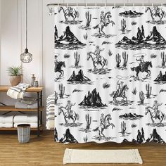 a shower curtain with black and white images of horses in the desert, on a wooden floor