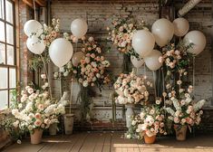 flowers and balloons are arranged in vases on the floor next to an old brick wall