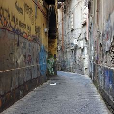 an alley way with graffiti on the walls