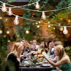 a group of people sitting around a dinner table