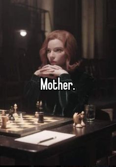 a woman sitting at a table playing chess with the words mother on her chest,