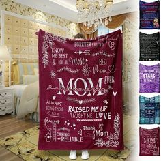 a red blanket with the words mom printed on it in multiple colors and styles, hanging from a chandelier