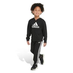 Make sure he's cozy and confident for the day ahead with this matching Boys 4-7 adidas Basic Fleece Zip-Up Hoodie & Jogger Pants Set. Make sure he's cozy and confident for the day ahead with this matching Boys 4-7 adidas Basic Fleece Zip-Up Hoodie & Jogger Pants Set. FEATURES 2-piece set includes: hoodie, pants Hoodie: attached hood, long sleeves, zip-up front, kangaroo pocket Pants: elastic waist, cuffed hemFABRIC & CARE Cotton, polyester Fleece construction Machine washable Imported Color: Bla Casual Hooded Activewear With Adidas Logo, Winter Adidas Activewear With Three Stripes, Adidas Long Sleeve Tracksuit Sportswear, Adidas Long Sleeve Tracksuit, Casual Adidas Activewear For Winter, Adidas Sporty Tracksuit For Sports, Adidas Sportswear Tracksuit, Adidas Sporty Long Sleeve Tracksuit, Sporty Adidas Tracksuit