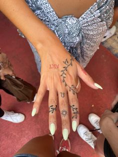 a woman's hand with tattoos on it