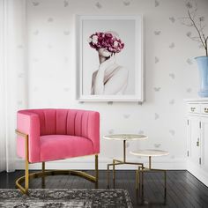 a pink chair and side table in a white room