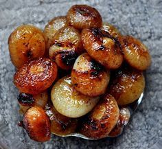 a glass bowl filled with fried potatoes on top of a table