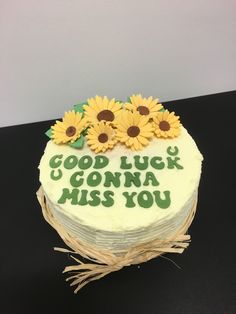 a cake decorated with sunflowers and the words good luck is going miss you