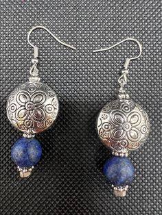 Beautiful antique silver bead with a sketch of a flower. Next there is a blue bead which gives this earring it's q unique style. Blue Sterling Silver Earrings With Flower Charm, Bohemian Blue Nickel-free Flower Earrings, Vintage Blue Flower Earrings, Nickel-free, Vintage Blue Flower Earrings Nickel Free, Blue Vintage Flower Earrings Nickel-free, Handmade Blue Sterling Silver Flower Earrings, Traditional Blue Flower Jewelry, Blue Sterling Silver Earrings With Silver Beads, Vintage Silver Beaded Nickel-free Earrings