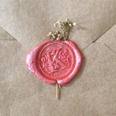 a wax stamp with the letter k on it