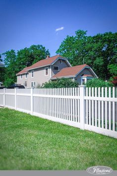 a white picket fence in front of a house