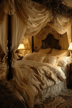 a bed with white drapes and pillows on it