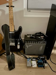 an electric guitar and amp are sitting on the floor