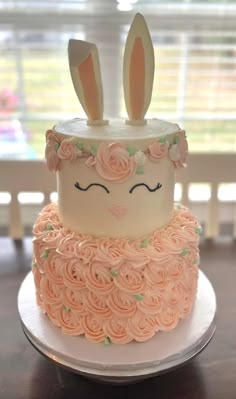 a cake decorated with roses and bunny ears