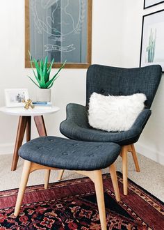 a chair and table in a small room with a rug on the floor next to it