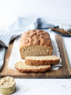 a loaf of bread sitting on top of a wooden cutting board