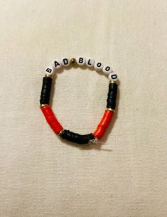 a red and black beaded bracelet with the word doubouba written on it