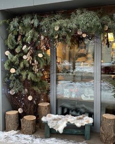 there is a bench in front of the window with snow on it and trees outside