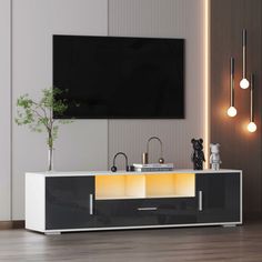 an entertainment center in a living room with modern lighting and artwork on the wall behind it