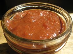 a jar filled with red sauce sitting on top of a table