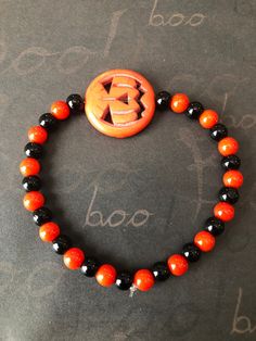 This is a Pumpkin Beaded Bracelet. It would make a spooky addition to a teen's or woman's Halloween costume. It would make a spooky gift for a teen or woman for Halloween. It has a flat orange pumpkin bead in the middle. It has 6mm orange and black glass beads. It was made with .8mm sturdy stretch string. I tie it several times to prevent breakage. It fits most teens and women. It stretches to fit on the wrist. All items are ready to be shipped I do combined shipping. Items ship in 2-5 business Halloween Jewelry With Round Letter Beads, Red Beaded Bracelets For Halloween Gift, Halloween Novelty Bracelet With Round Beads, Halloween Gift Stretch Bracelet With Round Beads, Halloween Bracelets With Letter Beads And Round Shape, Halloween Letter Beads Bracelet With Round Beads, Adjustable Red Beaded Bracelets For Halloween, Adjustable Black Beaded Bracelets For Halloween, Halloween Novelty Beaded Bracelets With Round Beads