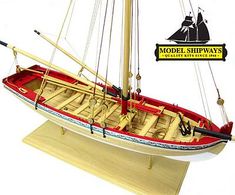 a model sailboat is shown on a wooden stand with the name model shipways above it