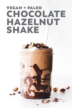 a chocolate shake in a glass with a straw sticking out of it's top