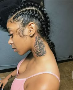 a woman with a tattoo on her neck sitting in front of a hair dryer