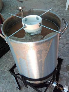 a large metal bucket sitting on top of a stand