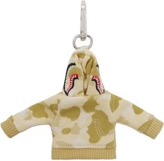 Keychain in silver tone. · Logo graphic camouflage pattern printed throughout · Lanyard clasp at top · Yellow graphic French terry charm at drop · Graphic embroidered at face and side · Logo flag at back face · H6 x W6 Supplier color: Yellow Shark Keychain, Fashion Pieces, Silver Accessories, Logo Graphic, Yellow Color, Tech Accessories, Lanyard, French Terry, Camouflage