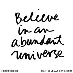 the words believe in an abundant universe are black and white with handwritten lettering on it