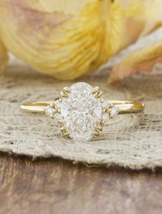 a close up of a ring with a flower in the background