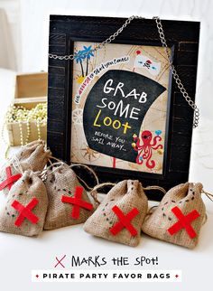 three bags with red crosses on them sitting in front of a sign that says grab some loot