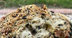 a bagel with sesame seeds and other toppings on it sitting in a basket