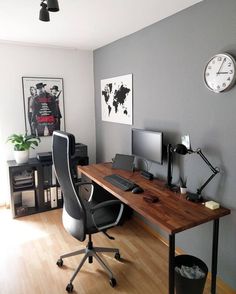 an office with a desk, chair and clock on the wall in front of it