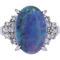 Mingle with the magic of timeless elegance with the Platinum 900 5.60 Carat Opal Ring. This exquisite piece features a mesmerizing black opal, boasting a total carat weight of 5.60 Carats, making it a captivating centerpiece. Surrounding this opulent gem are dazzling diamonds with a total weight of 0.28 Carats, adding a touch of sparkle and sophistication to the ring.Crafted with precision and finesse, this ring is made from luxurious Platinum 900, ensuring durability and a lustrous finish that will endure for generations. The opal's mysterious allure, coupled with the brilliance of diamonds, creates a harmonious symphony of beauty and prestige.Whether you're adding to your collection of fine jewelry or searching for a meaningful gift, the Platinum 900 5.60 Carat Opal Ring is a striking ch Luxury Oval Opal Ring With 17 Jewels, Modern Formal Opal Ring With Cabochon, Formal Modern Opal Cabochon Ring, Modern Formal Cabochon Opal Ring, Formal Opal Ring With Gemstone Accents, Luxury Polished Opal Ring, Oval Cabochon, Luxury Opal Ring With Oval Cabochon And Polished Finish, Luxury Polished Opal Ring With Oval Cabochon, Luxury Opal Gemstone Ring For Formal Occasions