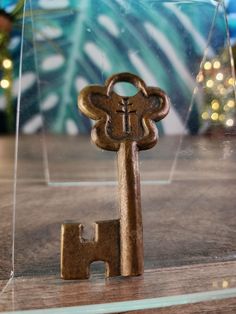 a key shaped like a monkey on top of a wooden table