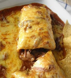 an enchilada with meat, cheese and tortilla chips