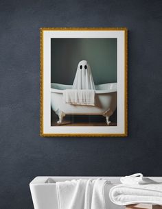 a bathroom with a white bathtub and towel on the wall next to it is framed in gold