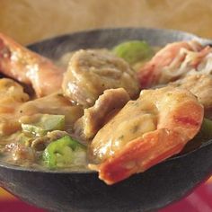 a close up of a bowl of food with shrimp and broccoli in it