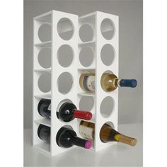 a white wine rack with six bottles in it and two empty ones on the side