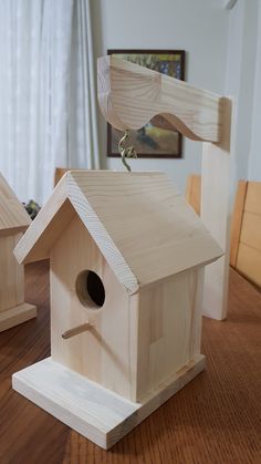 a wooden bird house sitting on top of a table