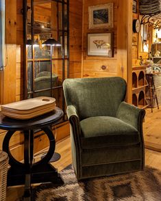 a living room filled with furniture and wooden walls