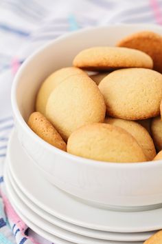 a white bowl filled with cookies on top of a table