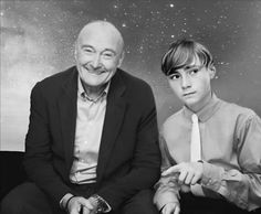 an older man sitting next to a young boy in front of a star filled sky